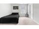 Neutral bedroom features single bed, black bedding, a window, and modern art at 222 Oak Branch - Lot 72 Trl, Garner, NC 27529