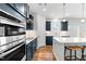 Close-up of kitchen featuring dark blue cabinets and stainless steel oven range at 222 Oak Branch - Lot 72 Trl, Garner, NC 27529