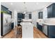 Stylish kitchen with dark blue cabinets, stainless steel appliances, and a spacious island at 222 Oak Branch - Lot 72 Trl, Garner, NC 27529