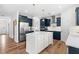 Bright kitchen showcasing dark blue cabinets, stainless steel appliances, and a white island at 222 Oak Branch - Lot 72 Trl, Garner, NC 27529