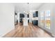 Bright kitchen with navy cabinets, stainless steel appliances, and hardwood floors leading to a backyard patio at 222 Oak Branch - Lot 72 Trl, Garner, NC 27529