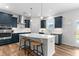 Modern kitchen featuring dark blue cabinets, a large island, and stainless steel appliances at 222 Oak Branch - Lot 72 Trl, Garner, NC 27529