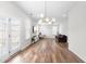 Bright living room with hardwood floors, modern light fixture, French doors, and multiple windows for ample light at 222 Oak Branch - Lot 72 Trl, Garner, NC 27529