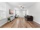 Bright living room featuring hardwood floors, a ceiling fan, television, and large windows providing lots of light at 222 Oak Branch - Lot 72 Trl, Garner, NC 27529