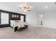 Bright main bedroom features a ceiling fan, neutral carpet and a dark accent wall at 222 Oak Branch - Lot 72 Trl, Garner, NC 27529