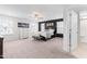 Spacious main bedroom with large windows, neutral carpet, fan, and a dark accent wall and modern decor at 222 Oak Branch - Lot 72 Trl, Garner, NC 27529