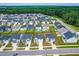 An aerial view of a neighborhood full of two-story homes with black roofs and lush green lawns at 222 Oak Branch - Lot 72 Trl, Garner, NC 27529
