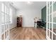 Office with wood flooring and French doors features a bookshelf and desk with computer at 222 Oak Branch - Lot 72 Trl, Garner, NC 27529