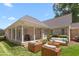Charming backyard of home showcasing a brick exterior, covered porch, grill, and outdoor seating area at 2333 Grey Gables Dr, Burlington, NC 27215