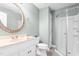 An airy bathroom with a glass-enclosed shower and a granite countertop vanity with a decorative mirror at 2333 Grey Gables Dr, Burlington, NC 27215