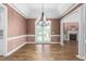 Elegant dining area with chandelier, wood floors, and French doors at 2333 Grey Gables Dr, Burlington, NC 27215