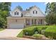 Beautiful home with a brick facade, trimmed bushes, and an attached two car garage at 2333 Grey Gables Dr, Burlington, NC 27215