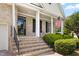 Inviting front porch with brick steps, columns, and black shutters with an American flag at 2333 Grey Gables Dr, Burlington, NC 27215