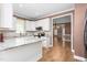 Open concept kitchen with white cabinets and view to dining area at 2333 Grey Gables Dr, Burlington, NC 27215