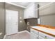 A convenient laundry room featuring white cabinets and a countertop for folding and laundry organization at 2333 Grey Gables Dr, Burlington, NC 27215