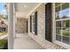 Covered side porch featuring brick columns, white trim, and black shutters at 2333 Grey Gables Dr, Burlington, NC 27215