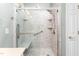 Updated shower with glass enclosure, marble-look tile, and convenient grab bar, providing safety and style at 2333 Grey Gables Dr, Burlington, NC 27215