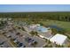 Stunning aerial view of community clubhouse, pool, tennis courts, parking and lush green landscaping at 236 Lucky Ribbon Ln, Holly Springs, NC 27540