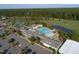Aerial view showcasing the community pool, clubhouse, and amenities amid verdant surroundings at 236 Lucky Ribbon Ln, Holly Springs, NC 27540