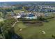 Community aerial view features golf course, pond, pool, and clubhouse for an active, vibrant lifestyle at 236 Lucky Ribbon Ln, Holly Springs, NC 27540