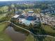 This aerial displays the community's swimming pool, clubhouse, golf course, and tennis courts at 236 Lucky Ribbon Ln, Holly Springs, NC 27540