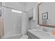 Bright bathroom featuring shower, vanity with stone countertop, decorative mirror, and ample storage at 236 Lucky Ribbon Ln, Holly Springs, NC 27540