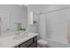 Bathroom featuring white vanity with stone countertops, shower, and storage at 236 Lucky Ribbon Ln, Holly Springs, NC 27540