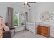 Charming Bedroom with soft natural light, light wood furniture, and a cozy armchair at 236 Lucky Ribbon Ln, Holly Springs, NC 27540