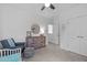Bedroom featuring neutral colors, light carpet, window, seating, and furniture at 236 Lucky Ribbon Ln, Holly Springs, NC 27540