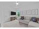 Bonus room featuring carpet, ceiling fan, seating, and a television at 236 Lucky Ribbon Ln, Holly Springs, NC 27540