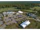 Aerial view showcases community amenities, including pool, clubhouse, and event space, surrounded by lush greenery at 236 Lucky Ribbon Ln, Holly Springs, NC 27540