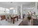 Open concept dining room with dark wood floors, modern chandelier, and views to other spaces at 236 Lucky Ribbon Ln, Holly Springs, NC 27540