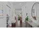 Spacious foyer leading to the living areas, featuring dark hardwood floors and neutral decor at 236 Lucky Ribbon Ln, Holly Springs, NC 27540