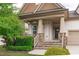 Inviting front porch with stone steps, decorative columns, and hanging flower baskets at 236 Lucky Ribbon Ln, Holly Springs, NC 27540
