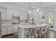 Updated kitchen with stainless appliances, quartz countertops, a backsplash, and an island at 236 Lucky Ribbon Ln, Holly Springs, NC 27540