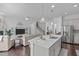 Open-concept kitchen featuring a large island, stainless steel appliances, and modern pendant lighting at 236 Lucky Ribbon Ln, Holly Springs, NC 27540