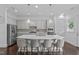 Kitchen with island, quartz countertops, pendant lighting and stainless steel appliances at 236 Lucky Ribbon Ln, Holly Springs, NC 27540