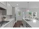 Gourmet kitchen featuring quartz countertops, custom cabinets, and stainless steel appliances at 236 Lucky Ribbon Ln, Holly Springs, NC 27540