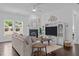 Bright and airy living room with a fireplace, built-in shelves, and hardwood floors at 236 Lucky Ribbon Ln, Holly Springs, NC 27540