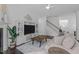 Relaxing living room with fireplace, TV, staircase, and neutral tones that bring the space together at 236 Lucky Ribbon Ln, Holly Springs, NC 27540