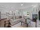 Open concept living room and kitchen area with lots of natural light and dark floors at 236 Lucky Ribbon Ln, Holly Springs, NC 27540