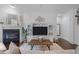 Cozy living room featuring a fireplace, built-in shelving, and a rustic wooden coffee table at 236 Lucky Ribbon Ln, Holly Springs, NC 27540
