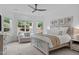 Serene main bedroom with a large bay window, decorative floral artwork, and a cozy sitting area at 236 Lucky Ribbon Ln, Holly Springs, NC 27540