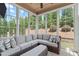 Sun room featuring a vaulted ceiling, large windows, and seating at 236 Lucky Ribbon Ln, Holly Springs, NC 27540