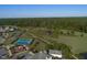 Aerial view features community tennis courts, greenery, and residential area at 236 Lucky Ribbon Ln, Holly Springs, NC 27540