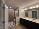 Bathroom featuring a shower with glass door and double sink vanity at 238 Alamosa Pl, Cary, NC 27519