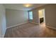 Well-lit carpeted bedroom includes a window and doorway to the ensuite bathroom at 238 Alamosa Pl, Cary, NC 27519
