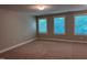 Carpeted bedroom boasts natural light through three large windows at 238 Alamosa Pl, Cary, NC 27519