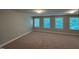 Spacious bedroom with carpet, three windows, neutral colors, and recessed lighting at 238 Alamosa Pl, Cary, NC 27519