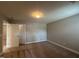 A carpeted bedroom with two doors and neutral paint is well-lit at 238 Alamosa Pl, Cary, NC 27519